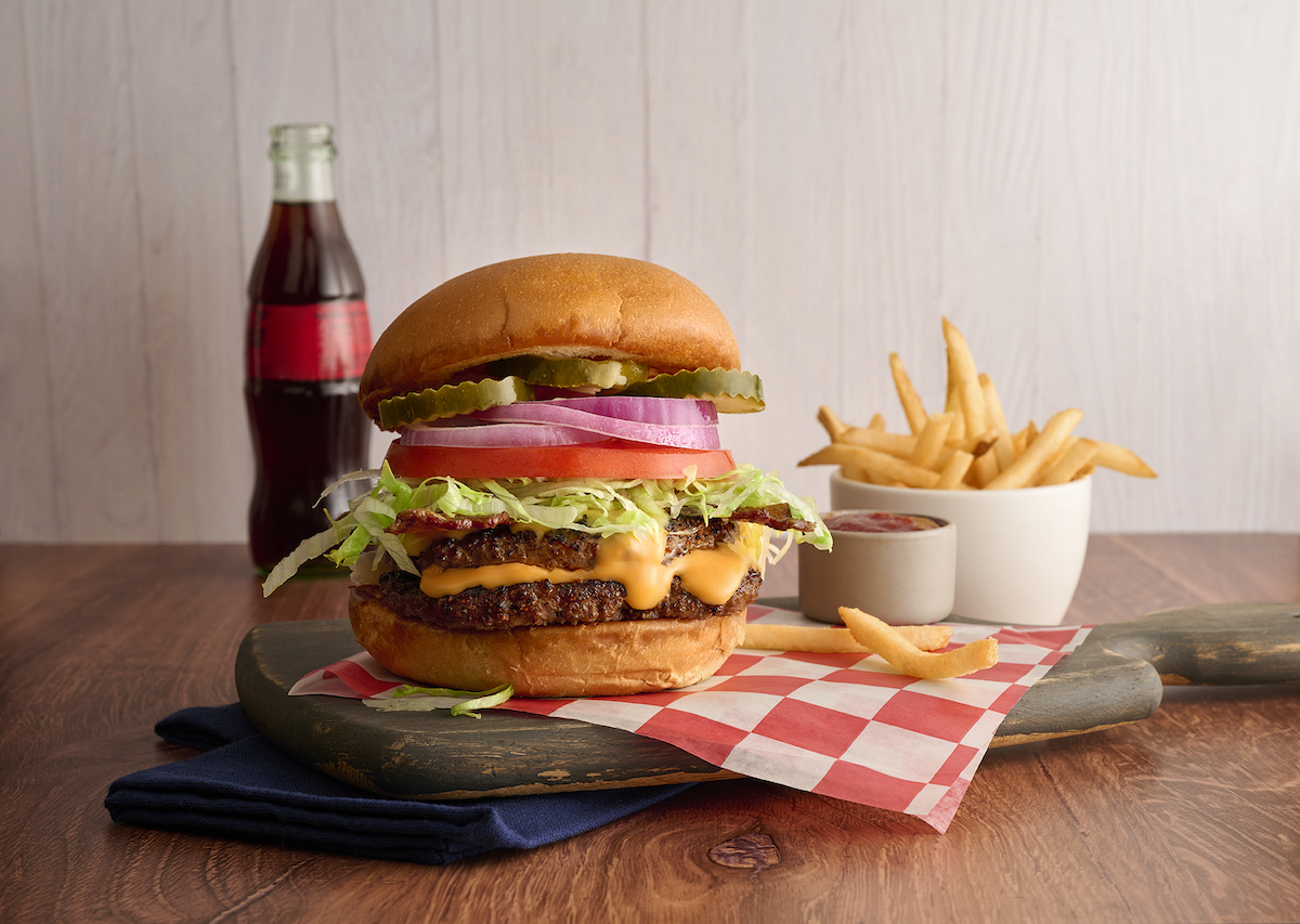 The Landry’s Smashburger, one of the dishes featured at the new Sugar Land location, comes stacked with two patties, cheese, bacon, and all the fixings. | Photo by Landry's
