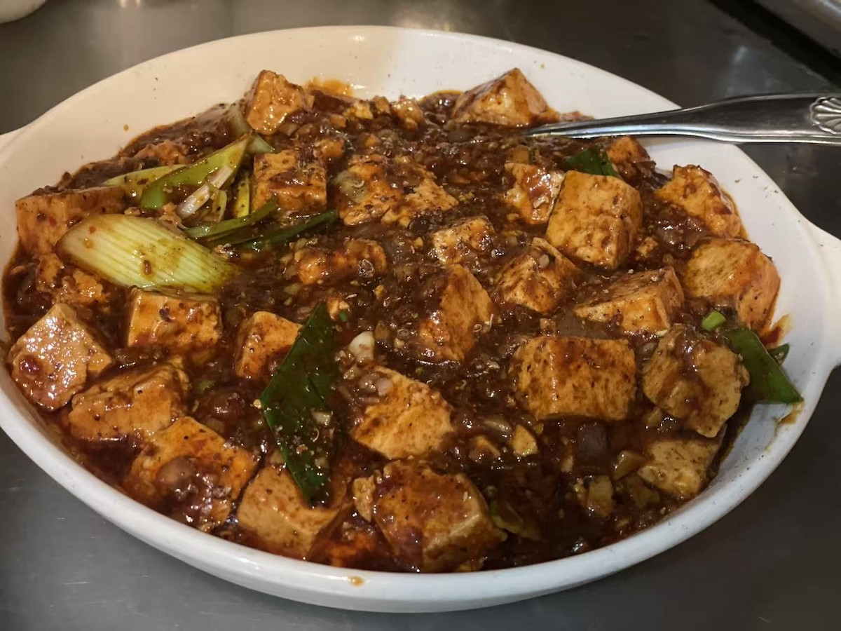 Mapo tofu at Masterpiece combines silky tofu and minced pork with Sichuan peppercorns for the dish’s signature spicy, numbing ma la effect. | Photo by Masterpiece
