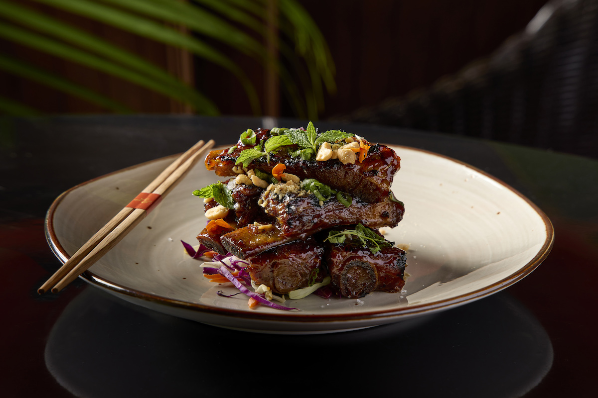 Chargrilled pork ribs are among the shareable dishes football fans can order while watching games in Le Colonial’s upstairs lounge. | Photo by Neil Burger