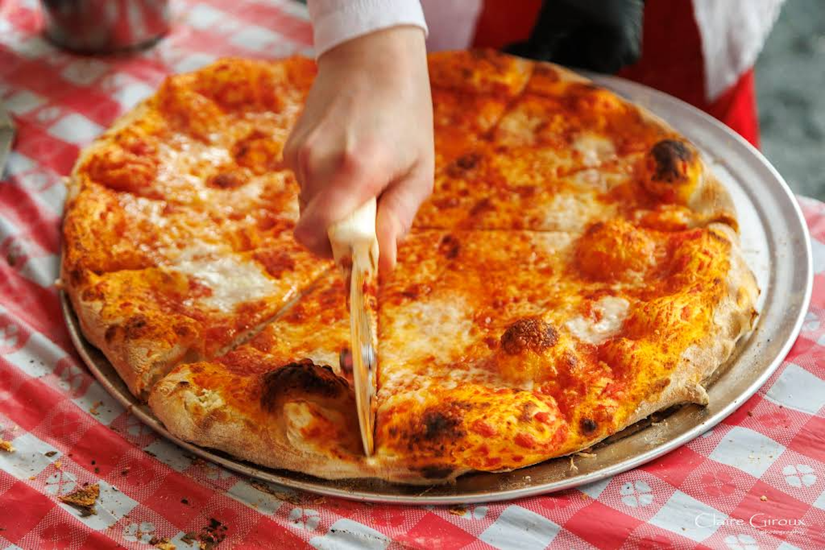 Salisburys Pizza DAL - DiningOut A classic cheese pizza gets sliced up at Salisbury’s Pizza, the new old-school neighborhood pizzeria in East Dallas’ Casa Linda. | Photo by Claire Giroux Photography