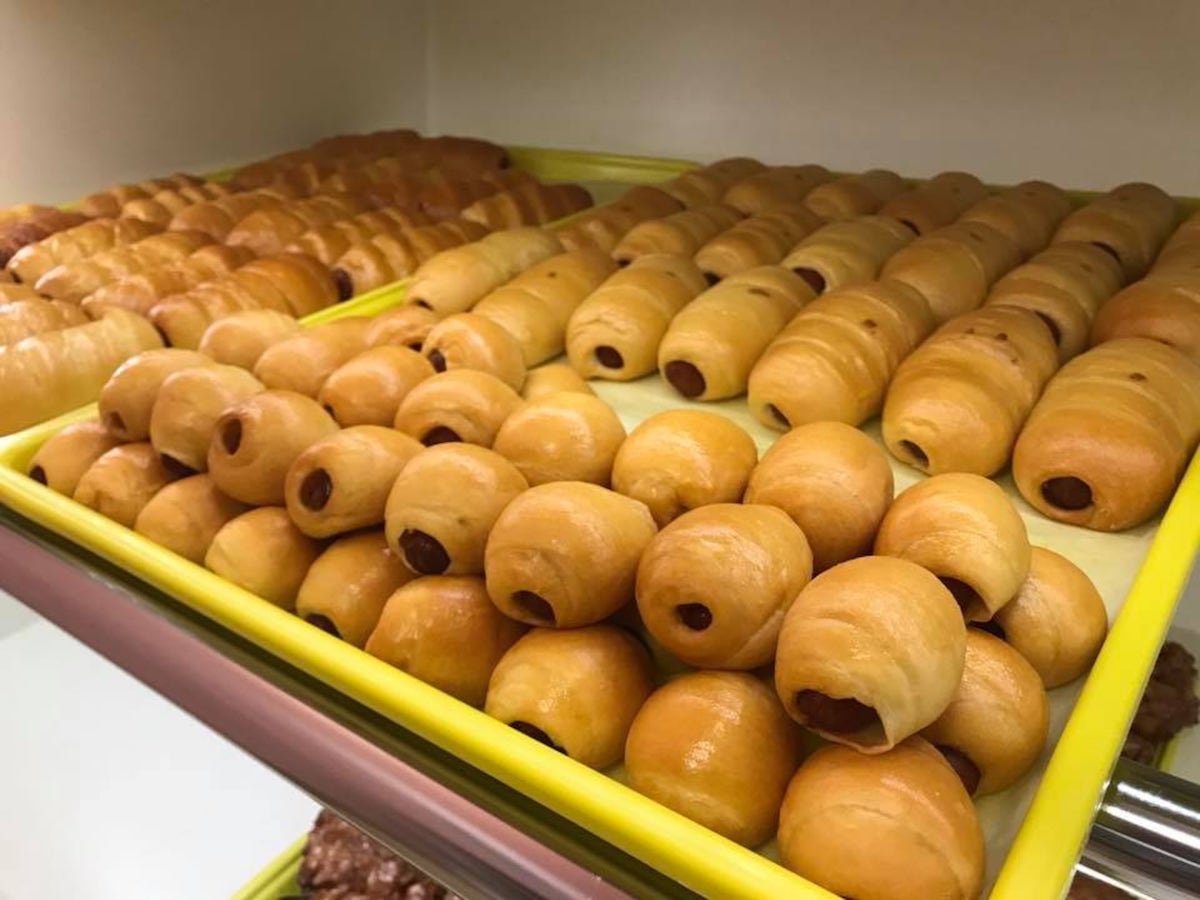 Marietta Donuts ATL - DiningOut Sausage kolaches fill the case at Marietta Donuts, where the savory pastries come stuffed with smoked sausage and cheese, with a jalapeño option for extra heat. | Photo by Marietta Donuts