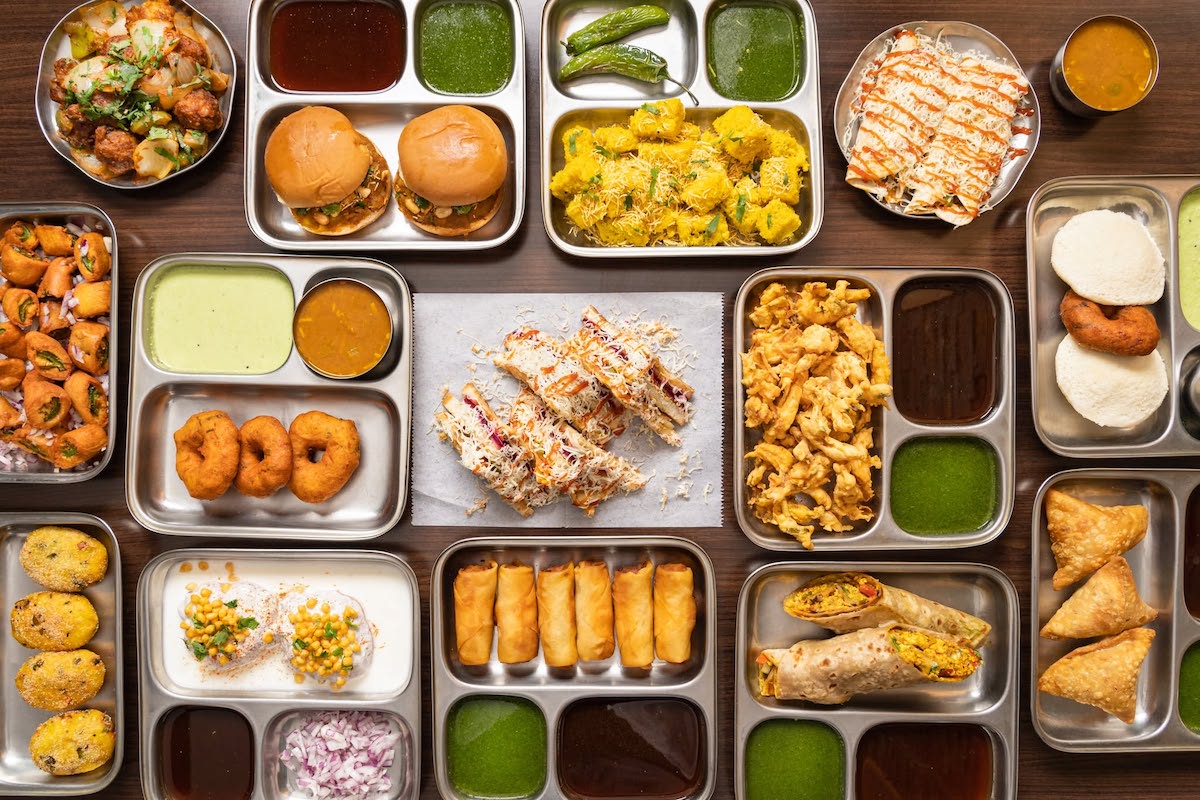 A colorful spread of Indian street food at Shiv Sagar showcases the restaurant's extensive menu, featuring pav, chaat, sandwiches, rolls and crispy snacks paired with house-made chutneys. | Photo by Shiv Sagar