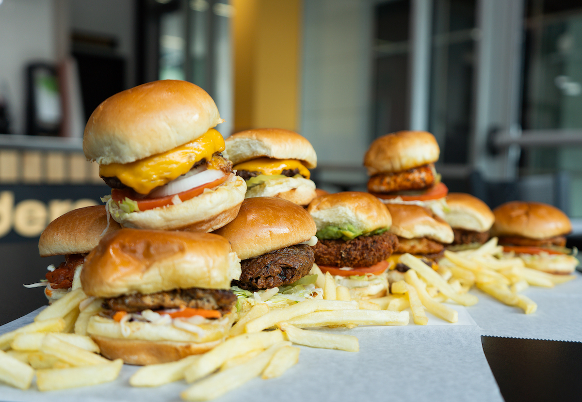 A towering spread of burgers, chicken sliders, and fries at Slip Sliders. | Photo by Slip Sliders