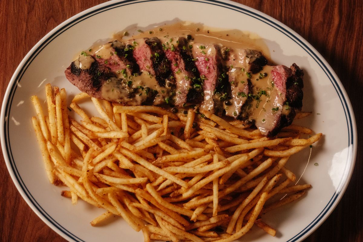 Kirkwood’s steak frites features prime bavette steak, crispy fries and a velvety brandy peppercorn cream sauce. | Photo by Quit Nguyen