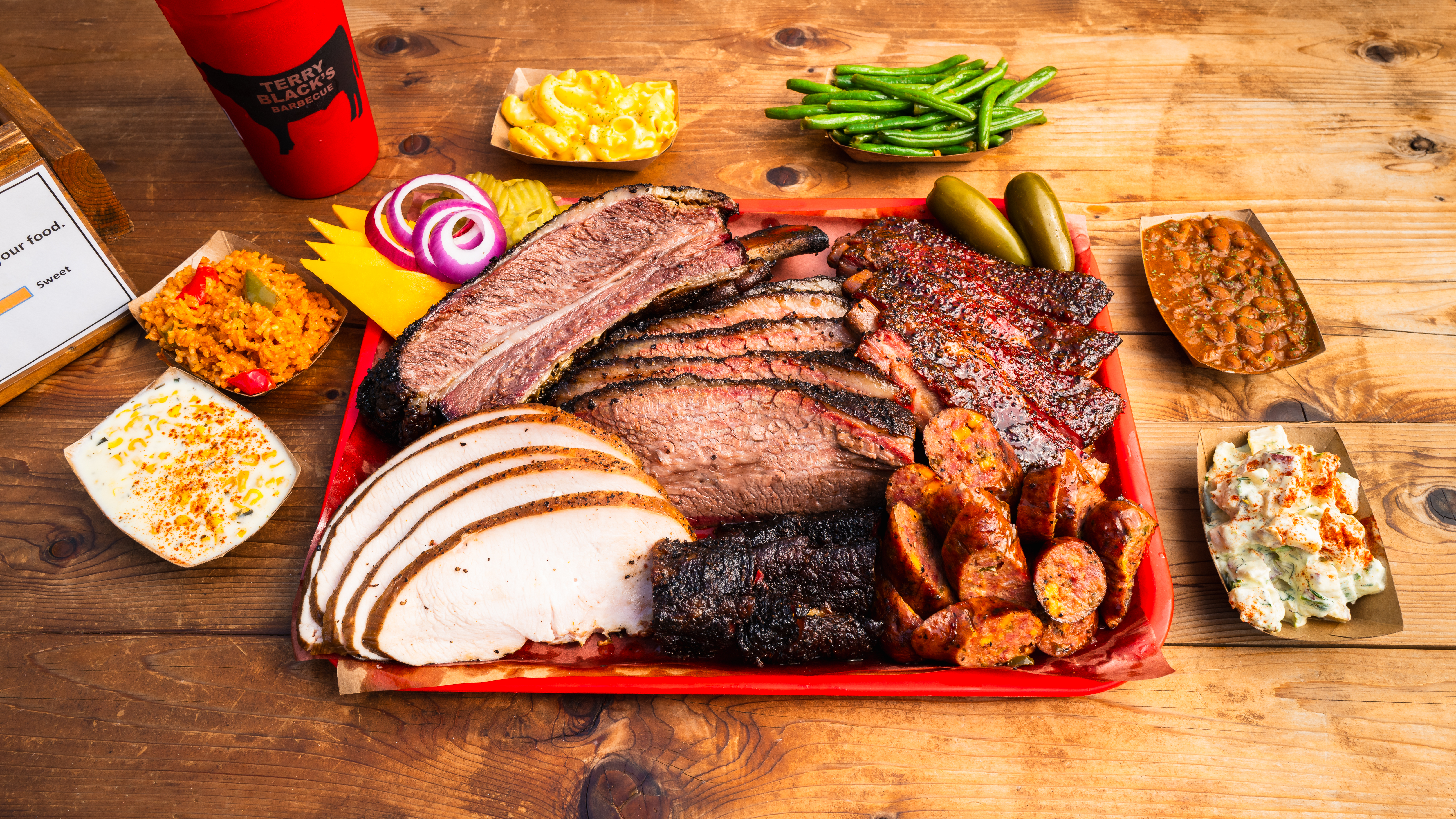 Terry Black’s Barbecue brings its famed Central Texas-style barbecue to Houston August 18 with brisket, beef ribs, pork ribs, turkey, house-made sausage and classic sides. | Photo by Terry Black's Barbecue