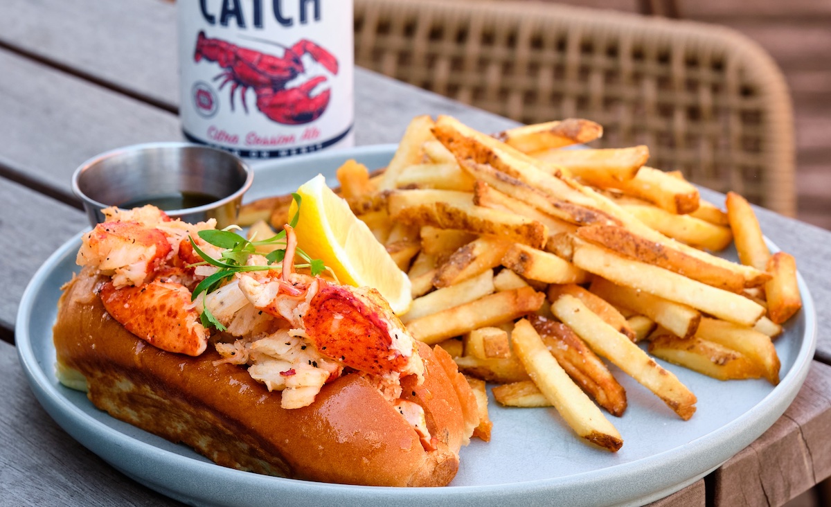 The Big Ketch Saltwater Grill offers several warm Connecticut-style lobster rolls, including its classic hot buttered version served with hand-cut fries. Photo by The Big Ketch Saltwater Grill
