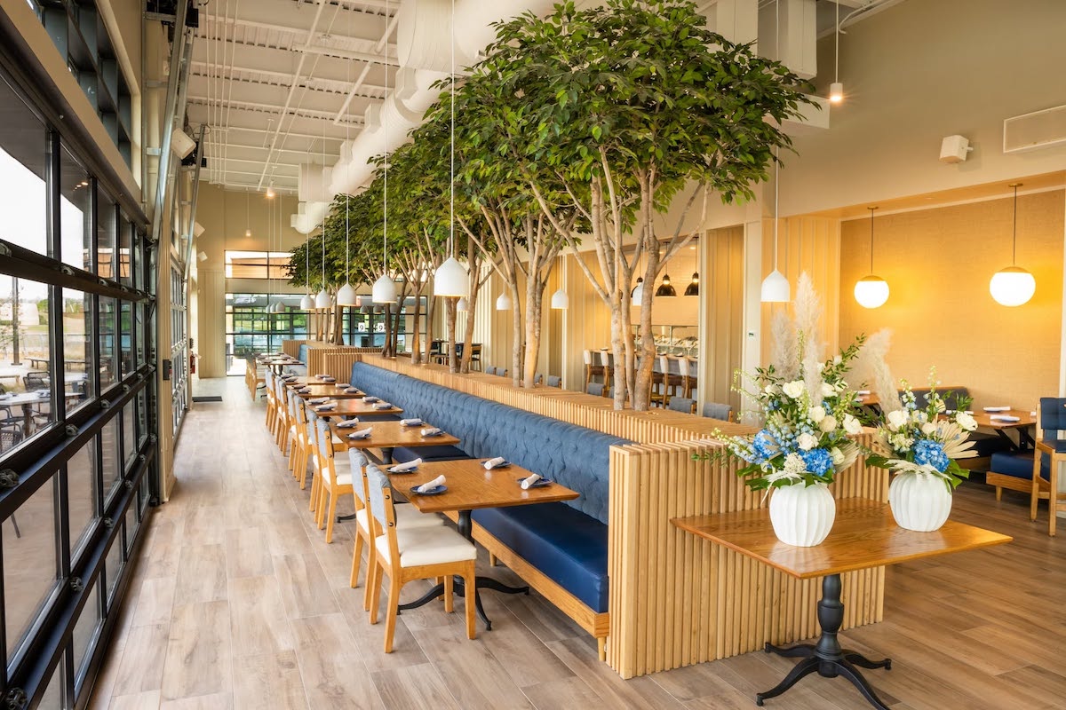 The bright, polished dining room at The Finch overlooks EpicCentral, where guests can pair contemporary American fare with views of the Illuvia water show. | Photo by The Finch