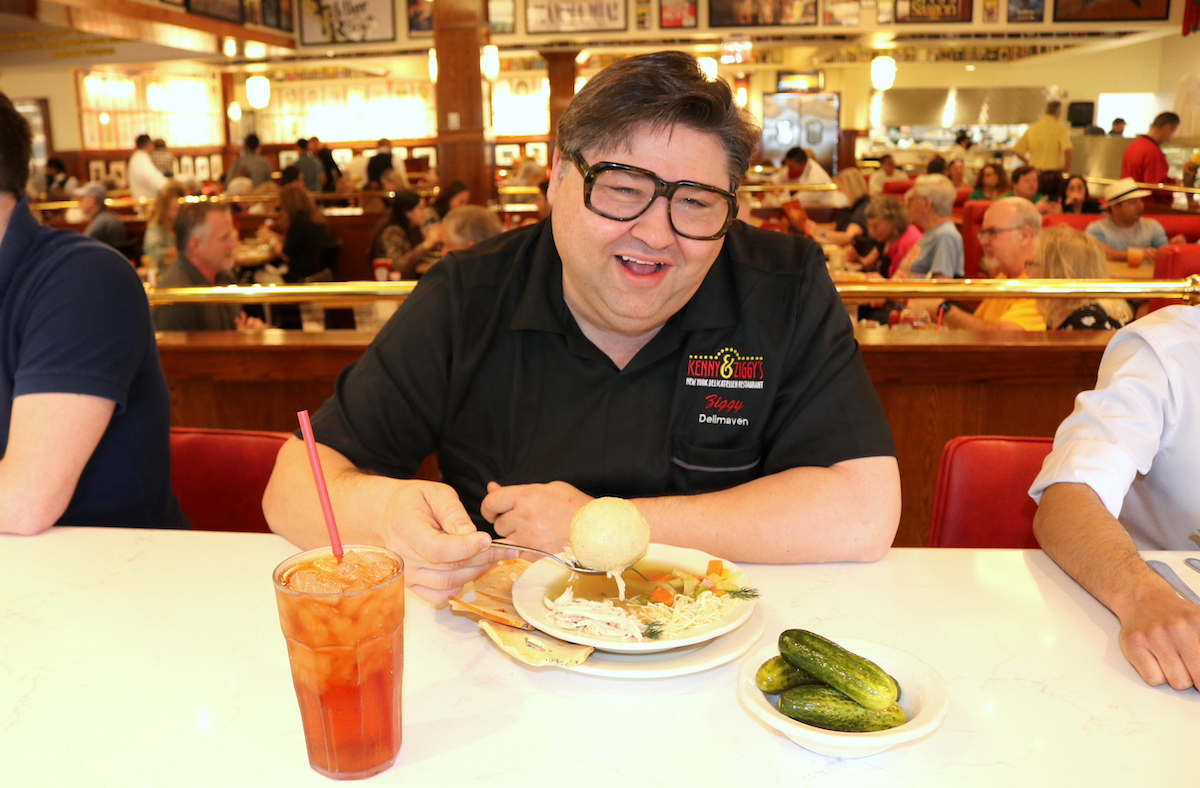 Kenny & Ziggy’s owner Ziggy Gruber shows off one of the deli’s famously oversized matzoh balls. | Photo by Kenny & Ziggy's