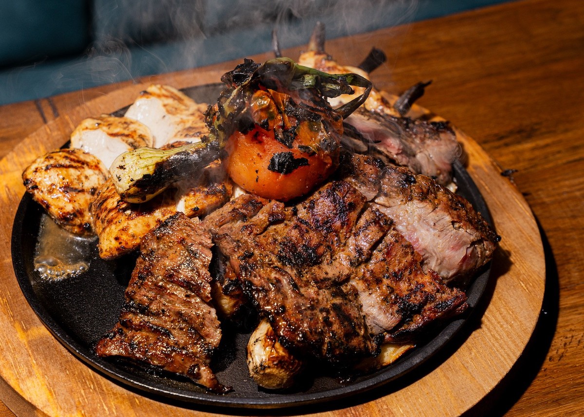 A sizzling mixed fajita platter at Johnny Rita’s Cocina y Cantina brings together grilled beef, chicken, and shrimp. | Photo by Johnny Rita's