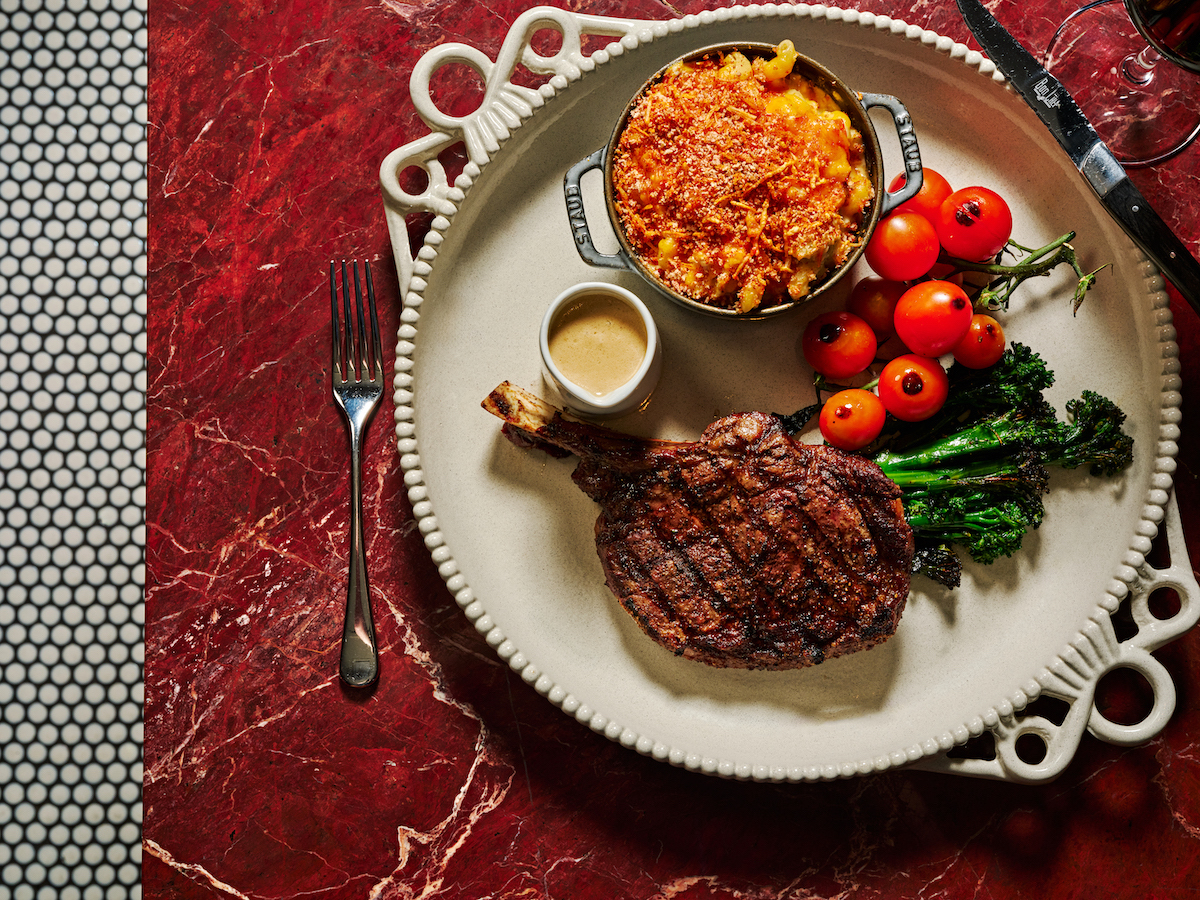 The 1855 Black Angus Cowboy Steak, served with crab mac and cheese, is among the comfort-forward dishes on The Betty’s new fall menu. | Photo by Andrew Thomas Lee