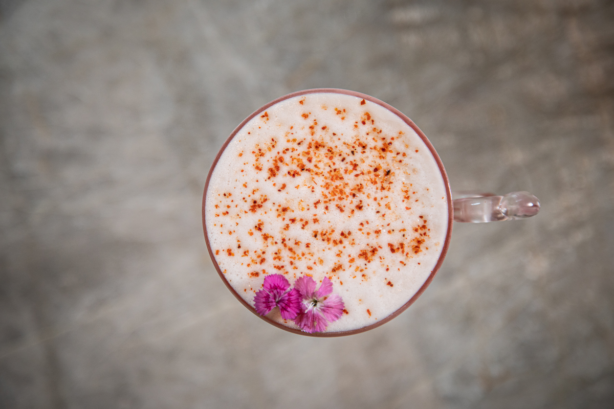 The Anarkali cocktail at Pataaka is finished with a floral garnish and a dusting of spice. | Photo by Spark Novus