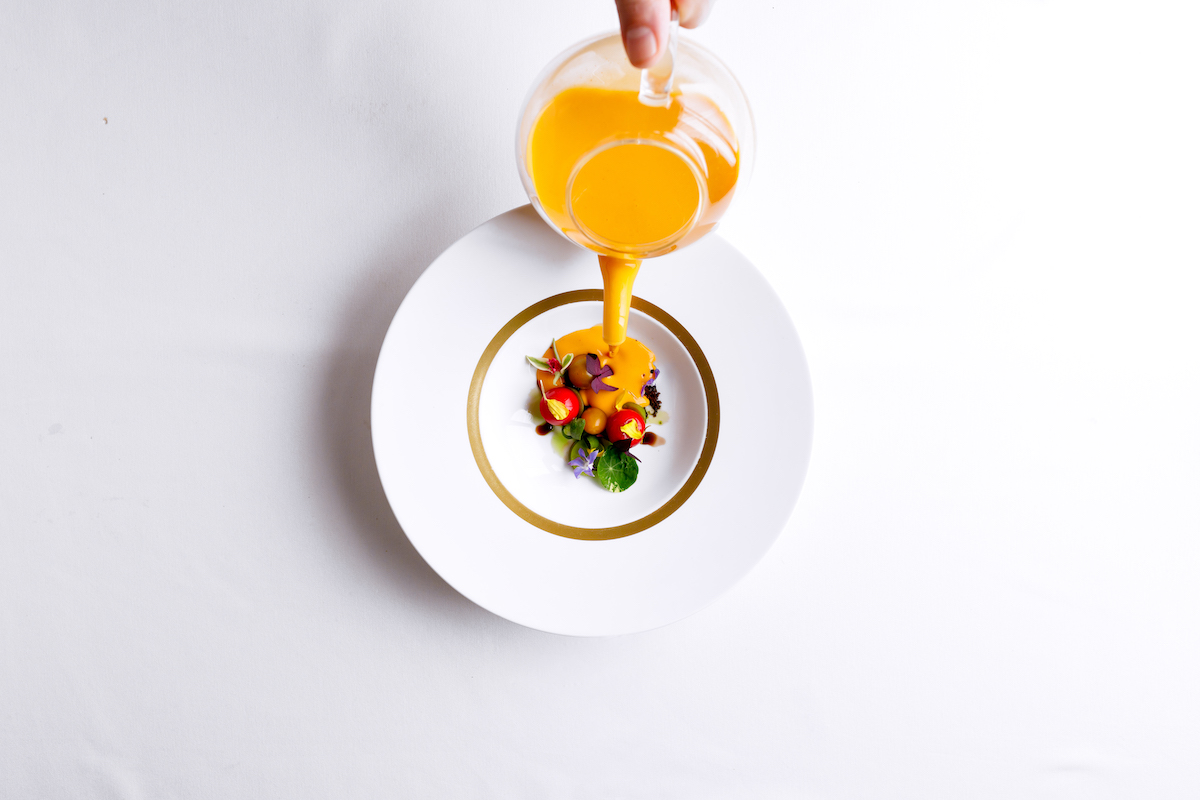 Summer gazpacho is finished tableside at Atlas, where chef Freddy Money pairs technical precision with playful presentations. | Photo by Tomas Espinoza
