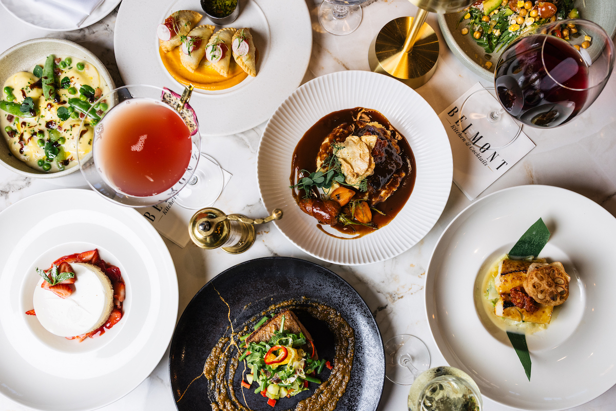 A spread of colorful dishes, cocktails, and wine showcases the polished dining experience at Belmont Kitchen & Cocktails, which launches its Lunch & Learn series this weekend. | Photo by Belmont Kitchen
