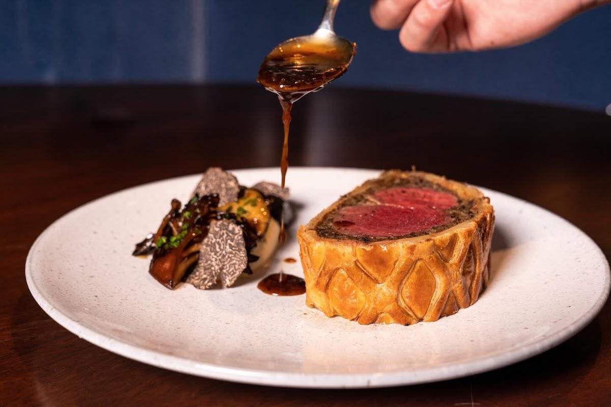 Bludorn’s beef Wellington is served with mushrooms and shaved truffles, and finished tableside. | Photo by Bludorn