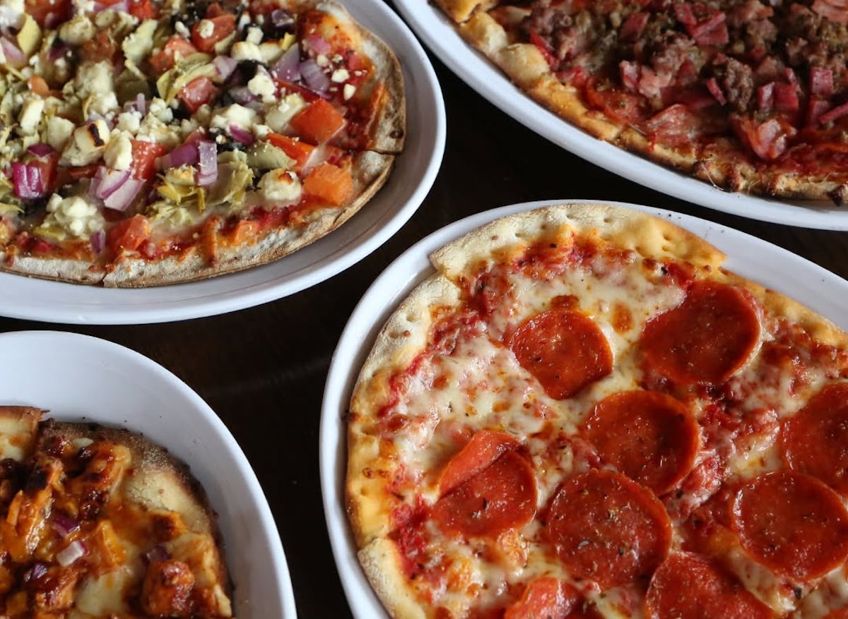 Campisi's DAL - DiningOut A spread of pizzas at Campisi’s, the runaway favorite among DiningOut Dallas readers asked to name the best pizza in town. | Photo by Campisi's