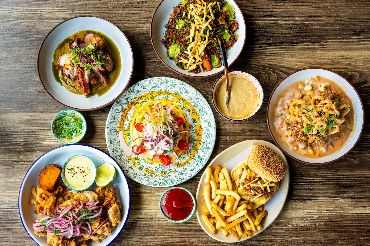 Tio Lucho ATL - DiningOut A colorful spread at Tio Lucho’s featuring handhelds, seafood dishes, and more that showcase chef Arnaldo Castillo’s take on Peruvian cuisine, blending traditional flavors with influences from his Southern upbringing. | Photo by Tio Lucho’s