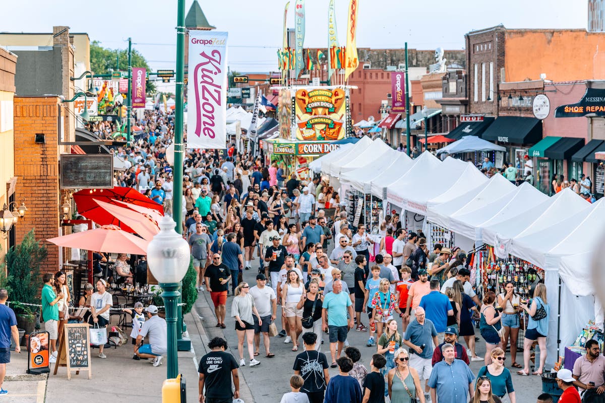 GrapeFest takes over Historic Main Street in Grapevine, drawing crowds for four days of wine tastings, food, live entertainment, and festival fun. | Photo by Grapevine CVB