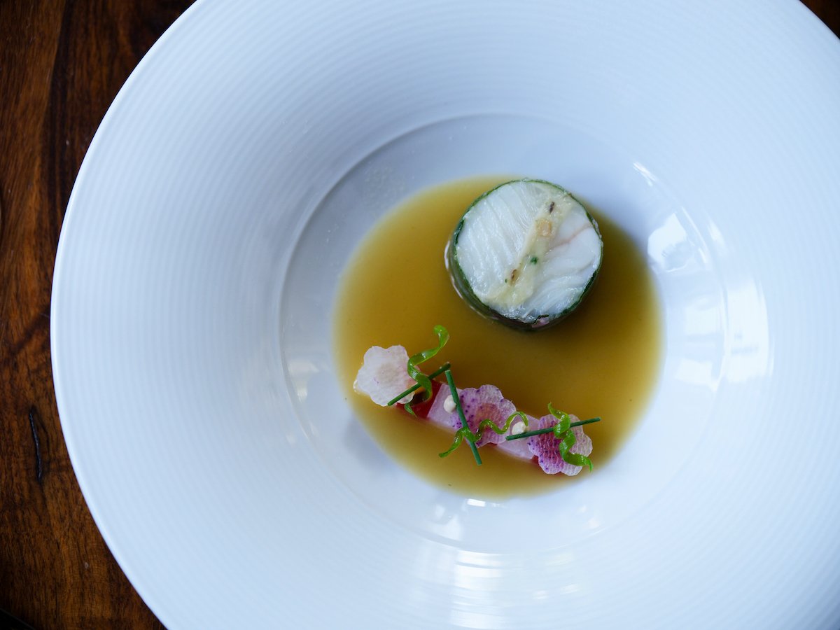 Lazy Betty’s new Alaskan halibut pairs the fish with daikon panaché, shiitake bouillon, and duck egg yolk fudge. | Photo by Matt Wong