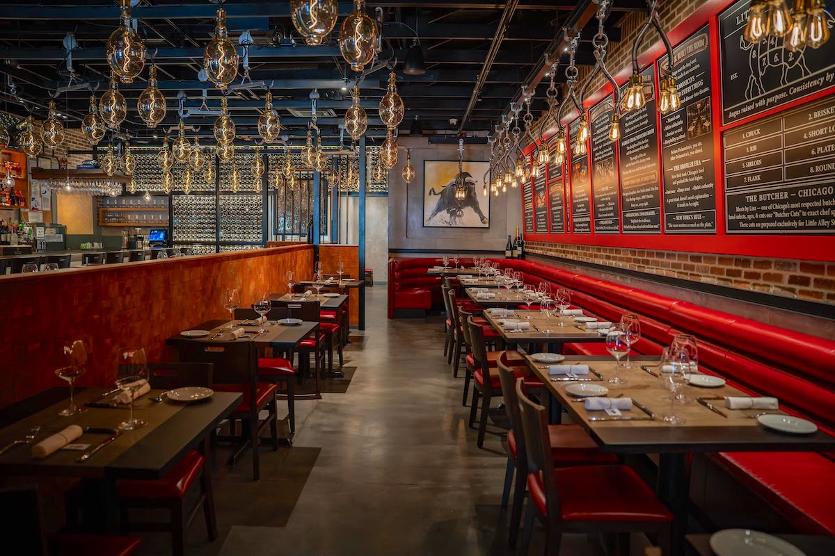 Little Alley Steak ATL - DiningOut Little Alley Steak’s new Alpharetta dining room carries the steakhouse’s signature red-and-black look. | Photo by Little Alley Steak