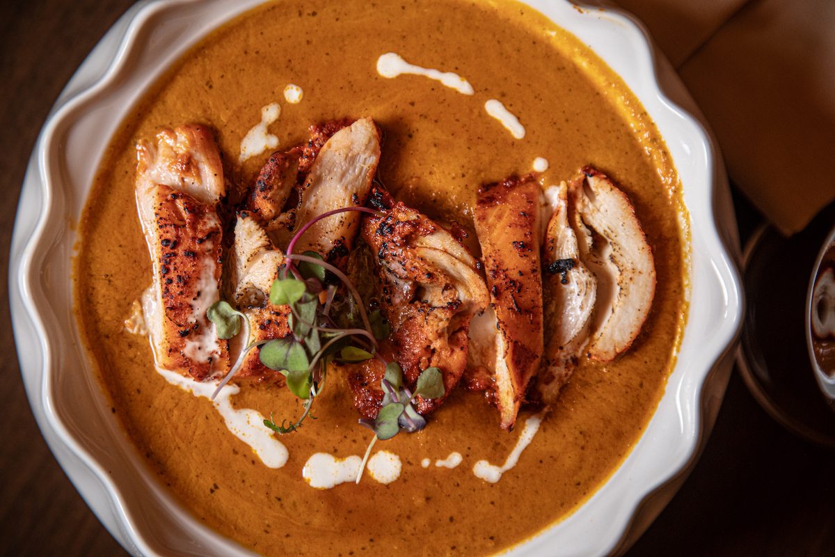 Pataaka’s Old Delhi Butter Chicken pairs roasted chicken with a rich tomato and fenugreek sauce. | Photo by Spark Novus
