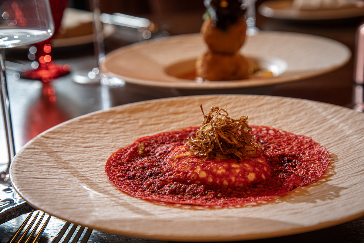 Pataaka puts a modern spin on saag with creamy burrata and crisp garnishes. | Photo by Spark Novus