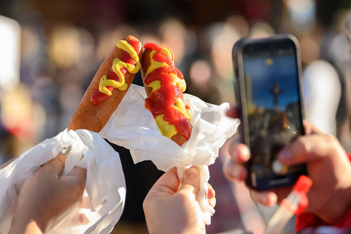 Fletcher’s Original Corny Dogs remain one of the State Fair of Texas’ most iconic eats—and a requisite photo op. | Photo by the State Fair of Texas