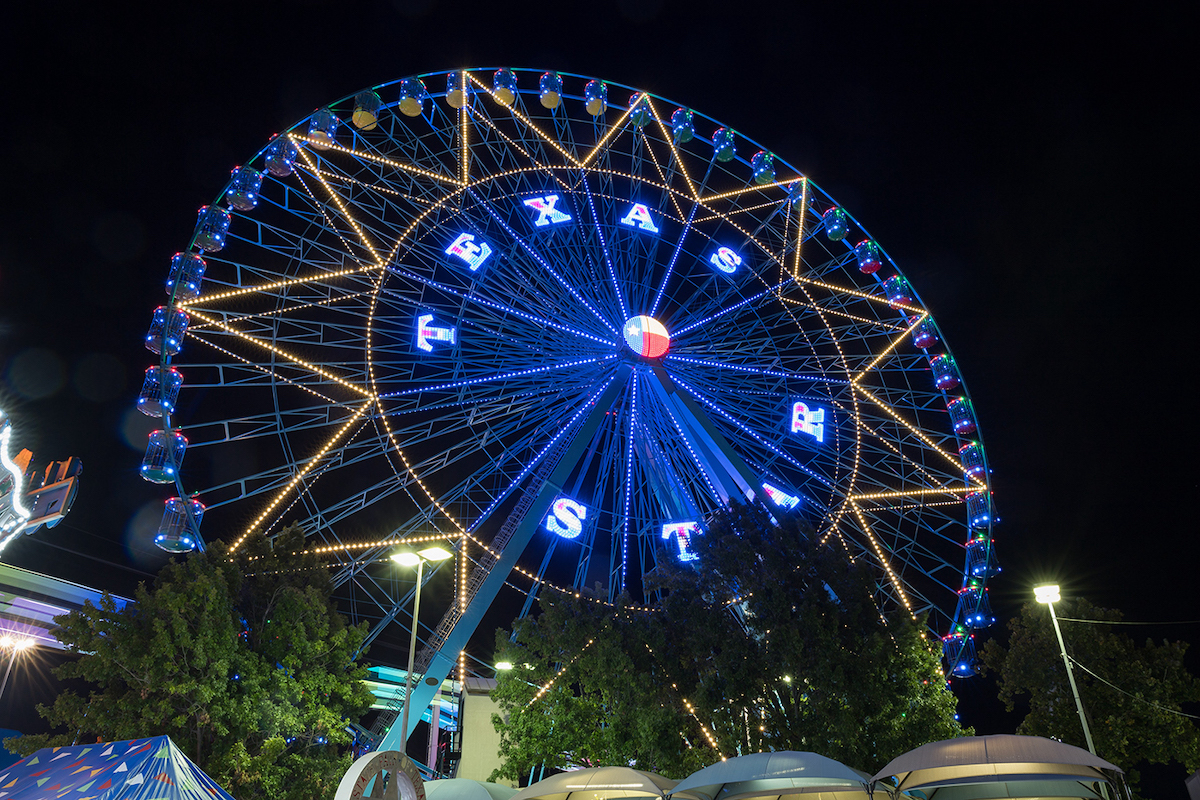 The Texas Star lights up the Midway after dark at the State Fair of Texas. | Photo by the State Fair of Texas