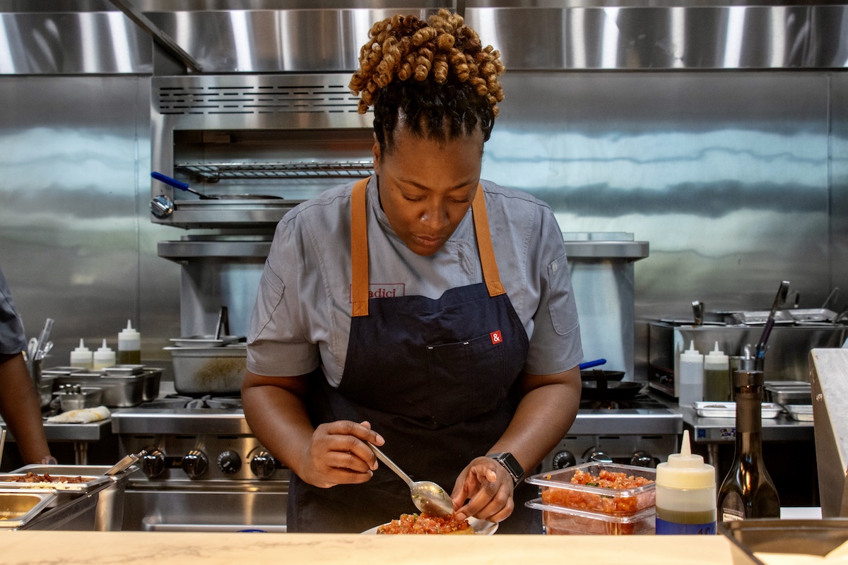 Tiffany Derry prepares bruschetta in the kitchen at Radici Wood Fire Grill, her Italian concept with locations in Farmers Branch and Grand Prairie. | Photo by Mia Valdez