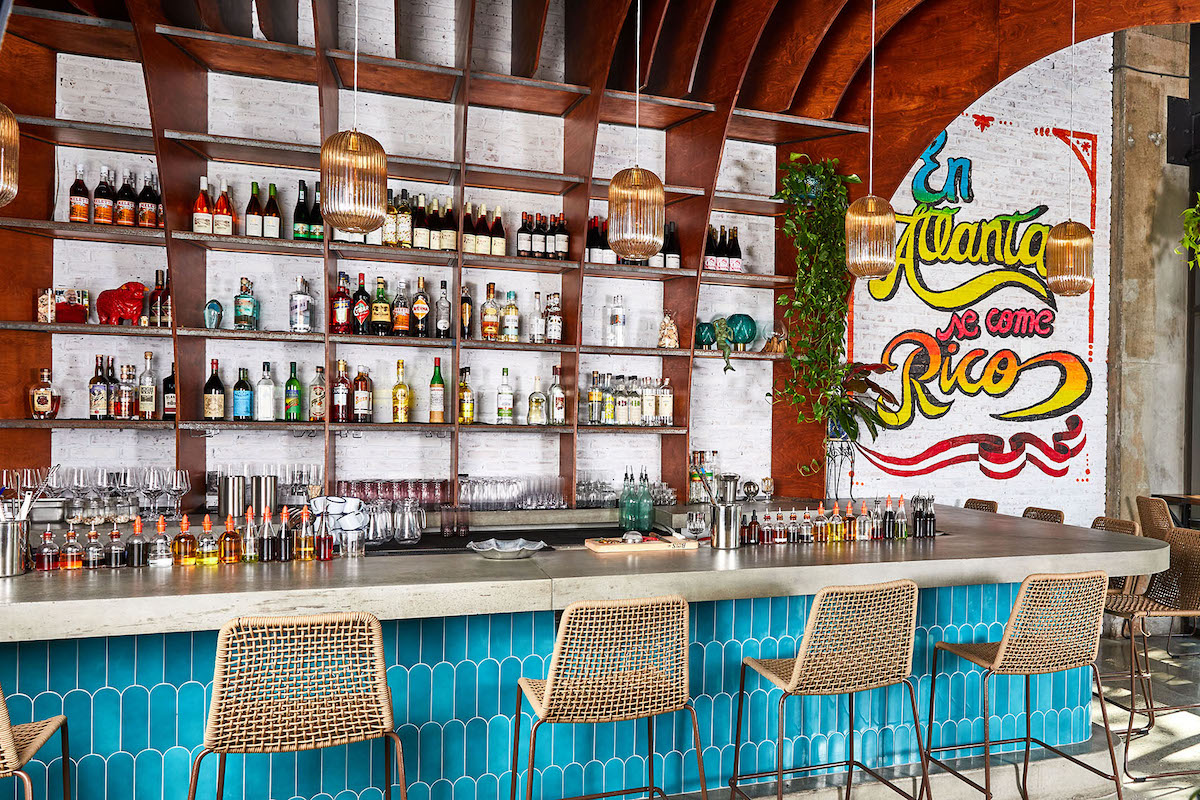 The bar at Tio Lucho’s features a colorful “En Atlanta se come rico” mural, a fitting backdrop for chef Arnaldo Castillo’s Peruvian restaurant in Poncey-Highland. | Photo by B. Garrot
