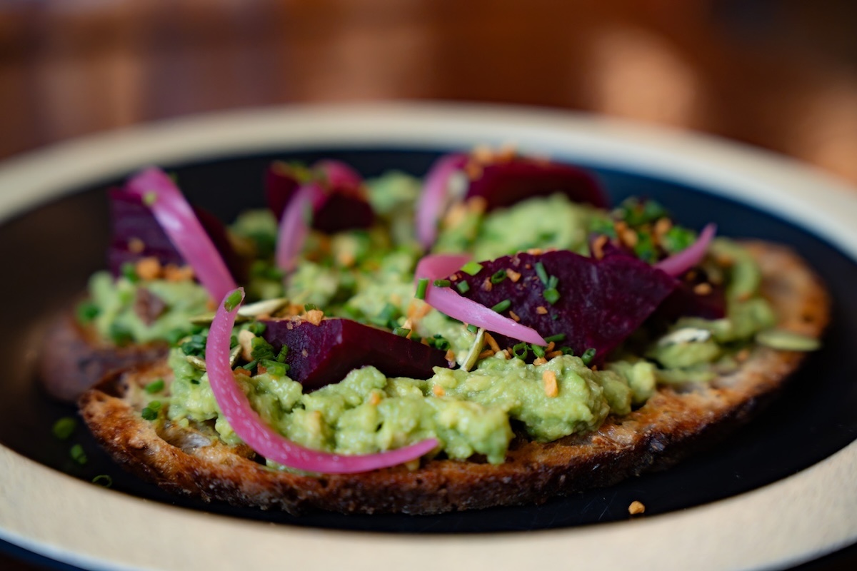 NYC_Château Le Woof_Heirloom Beet Avocado Toast and Steak Sweet Potato Hash - DiningOut And for the humans, an heirloom beet and avocado toast. | Photo courtesy of Château Le Woof