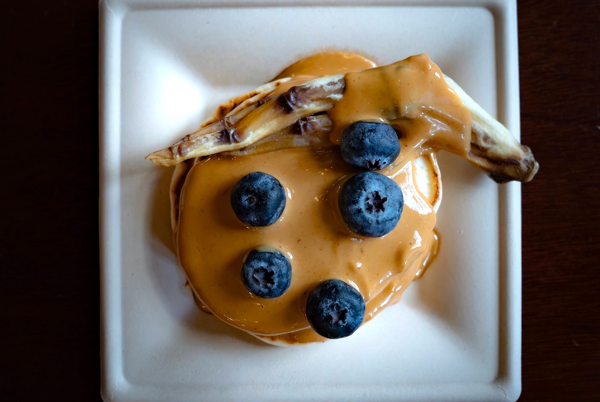 NYC_Château Le Woof_duck_pancake_dog - DiningOut The Duckin’ Pancakes topped with a dehydrated duck foot. | Photo courtesy of Château Le Woof