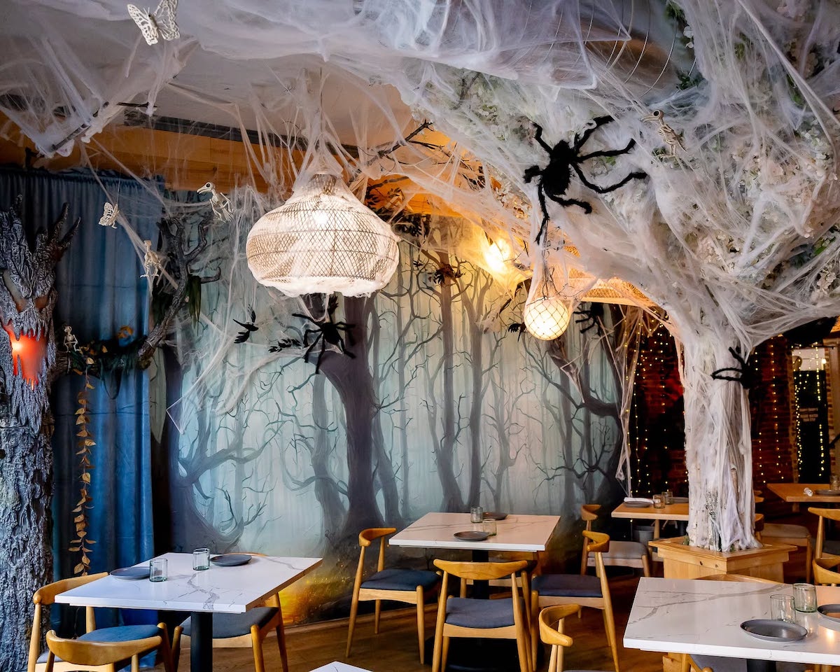 Giant spiders and thick cobwebs transform the dining room at Hamp & Harry’s in Marietta into a creepy, haunted forest. | Photo by Hamp & Harry’s